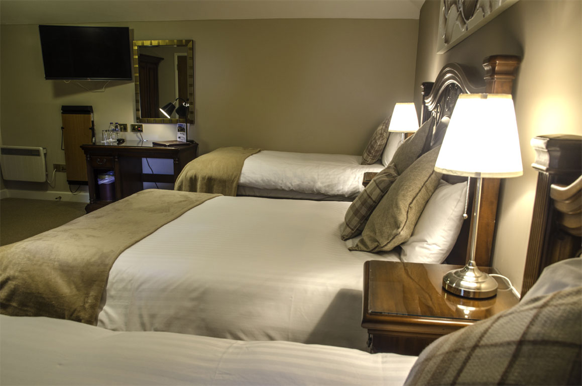 Two single beds and a double, with tv and desk